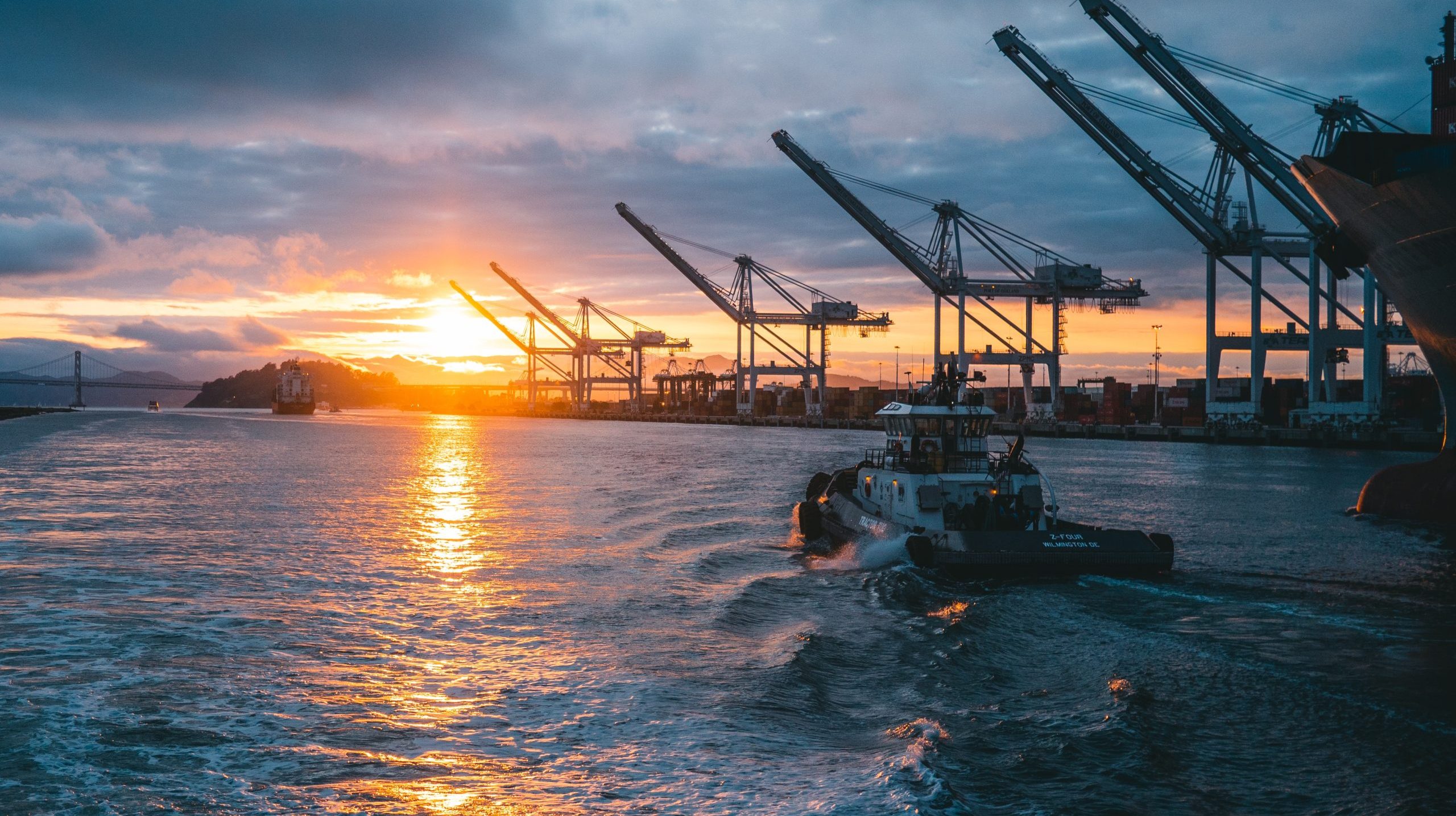 Panoramic shot of oil rigs at sea with a beautiful sunset in the background, under cloudy sky a panoramic shot of oil rigs at sea with a beautiful sunset in the background, under cloudy sky